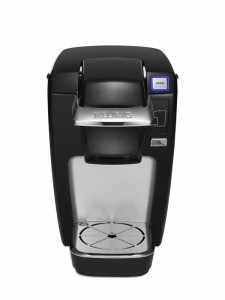 Black coffee maker with brew button and water reservoir.