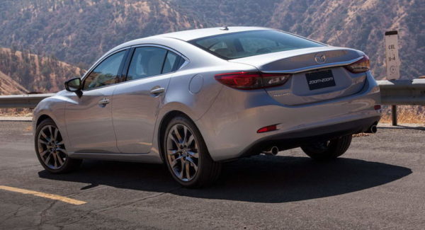 Silver sedan parked on a mountain road