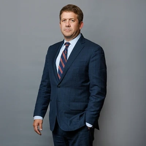 Business professional in a formal suit with a serious expression