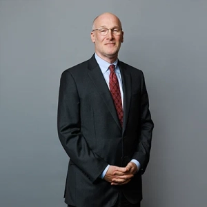 Business professional in a suit standing confidently