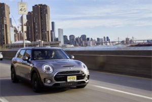 Stylish gray Mini Cooper driving on a city highway