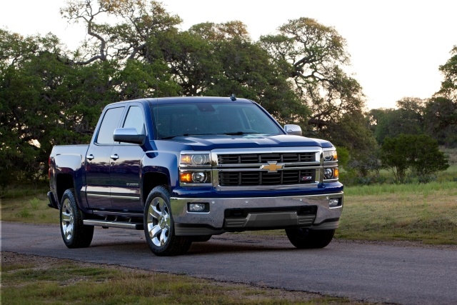 A blue Chevrolet Silverado pickup truck parked on a rural road.
